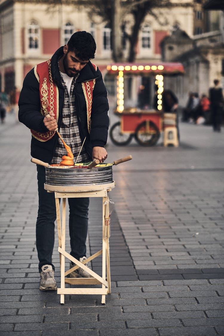 A Man Selling Food On The Street