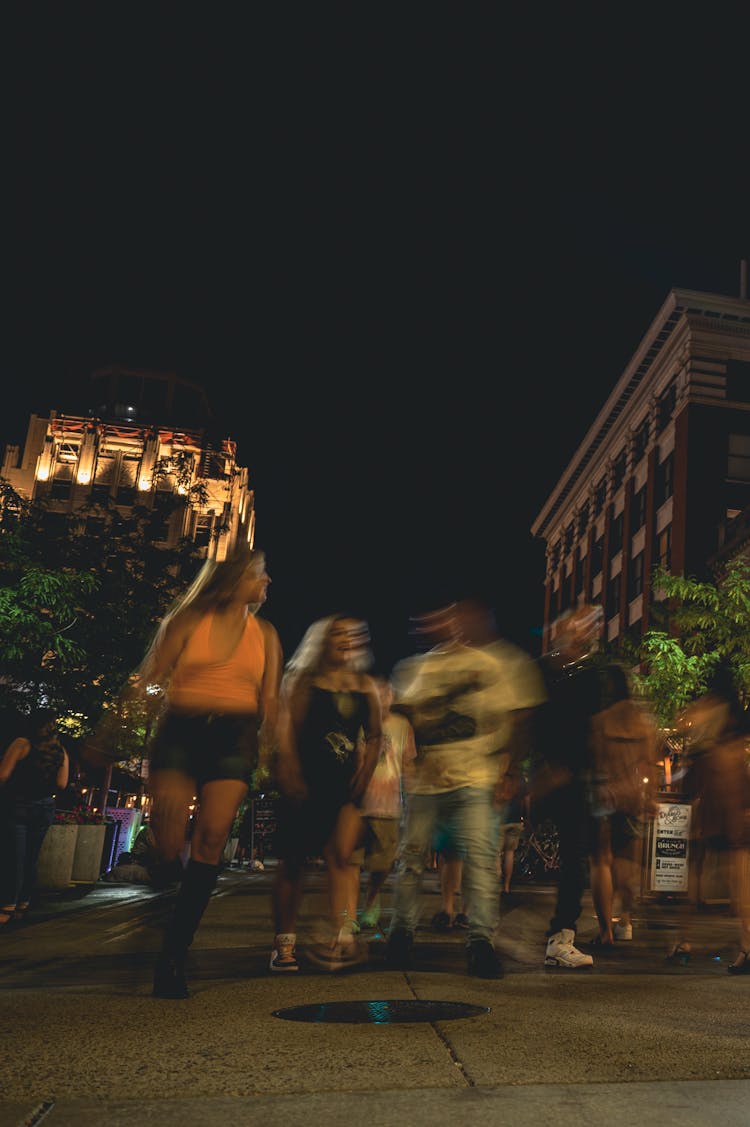 Friends Walking On The Street During Night Time