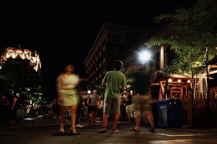 People Walking On The Street During Night Time