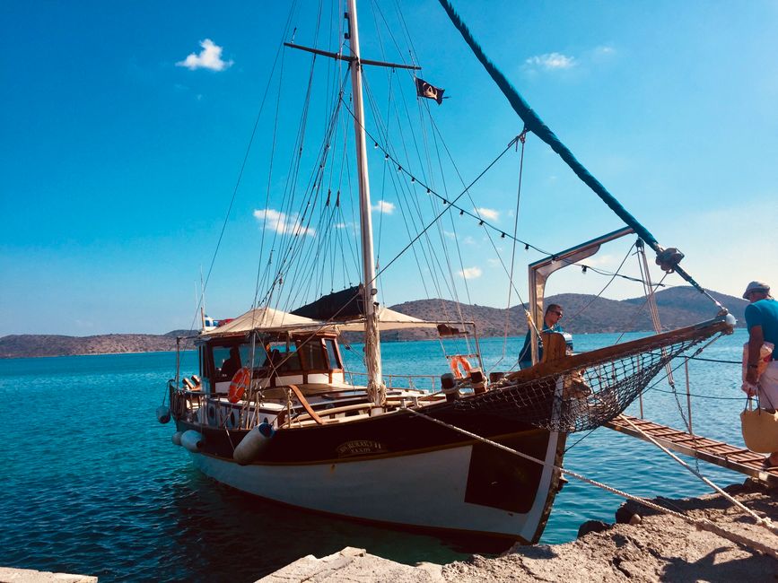 Unbeatable Full Day Yacht Tour in Catamaran Naxos Greece Review: An Unforgettable Day on the Aegean Review 2026 - A beautifully moored sailboat by a serene lakeshore with clear blue skies.