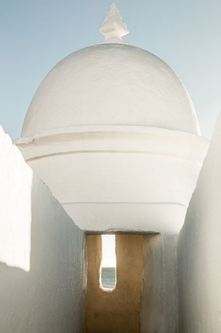 Elegant white domed structure in Salvador, Brazil, showcasing traditional architecture and summer sunlight.