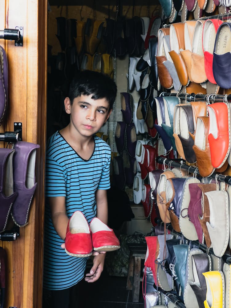 Boy Selling Shoes On Market