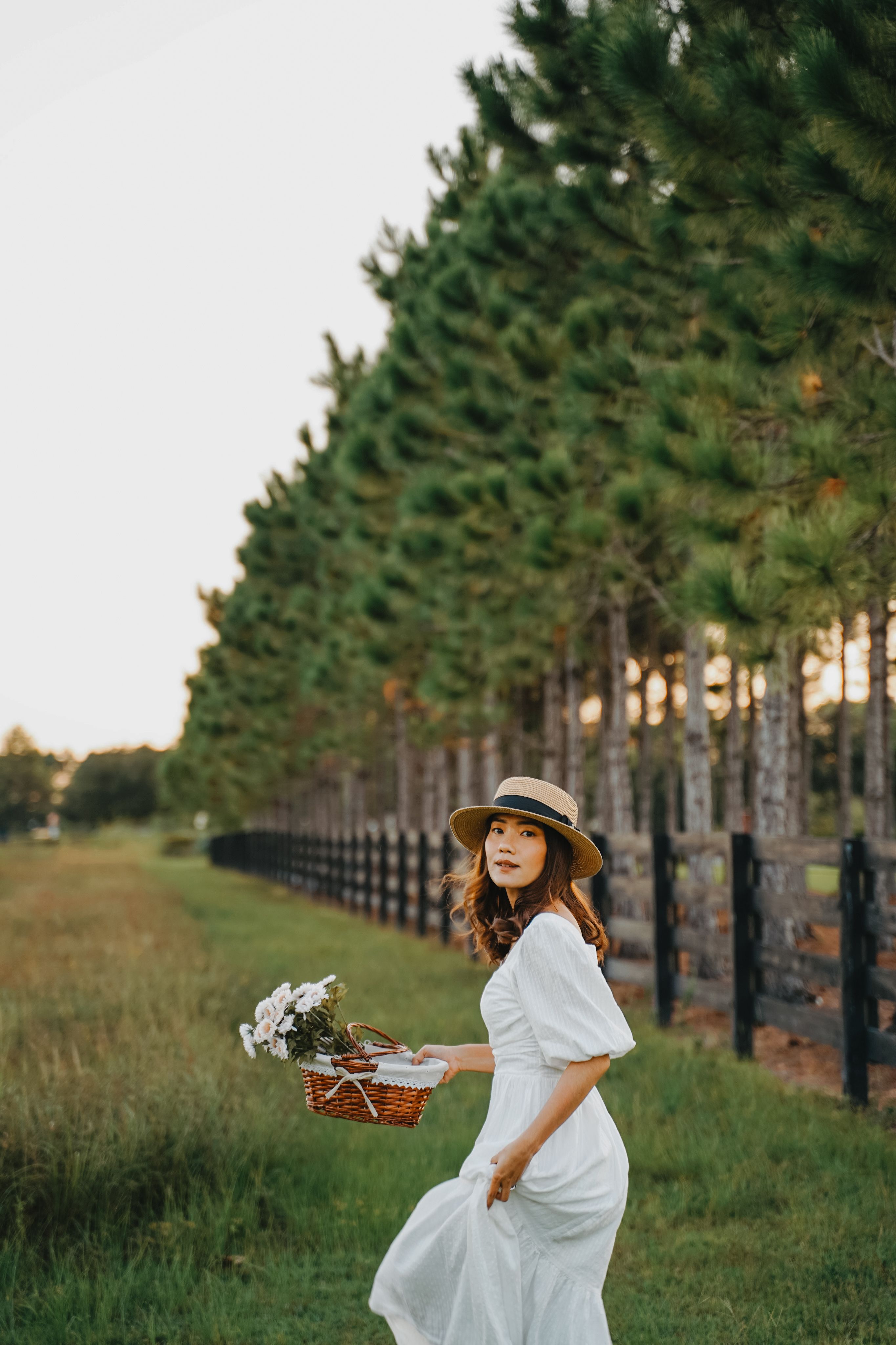 Woman in Floral Dress Holding Basket of Fruits · Free Stock Photo