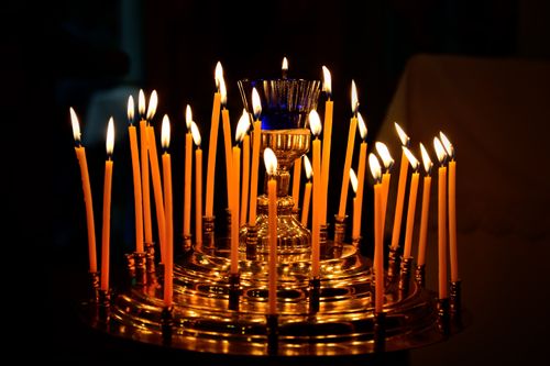 Free A captivating display of lit candles on a golden holder, creating a warm and festive ambiance. Stock Photo