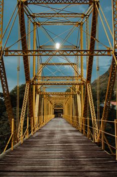 Rustic yellow suspension bridge in Honda, Colombia during daylight.