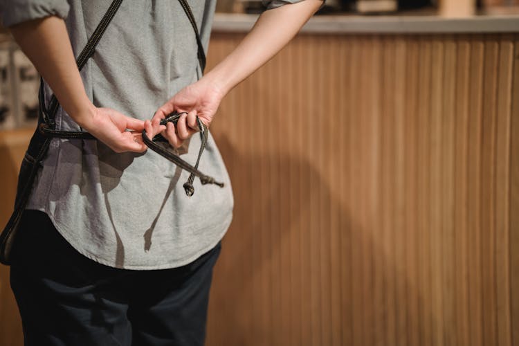 Person Tying Apron