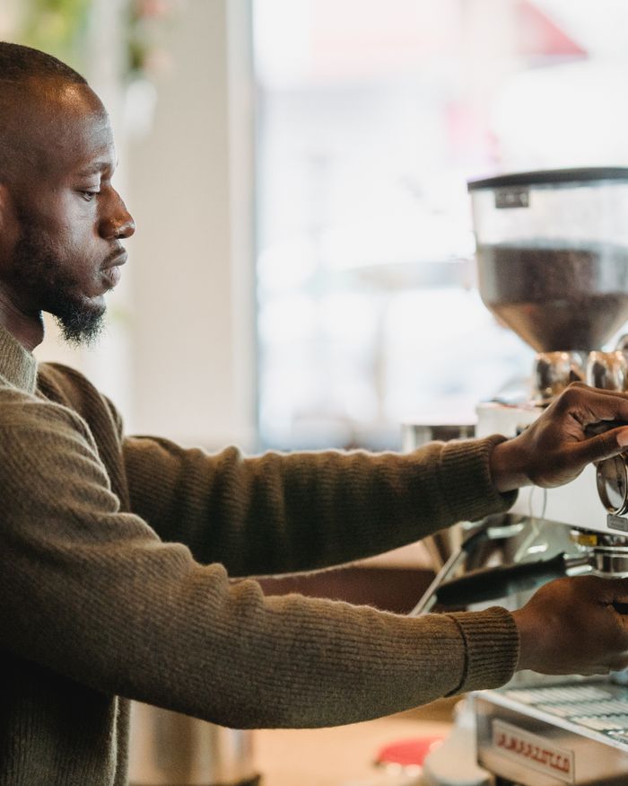 A barista pulling a shot on the espresso machine