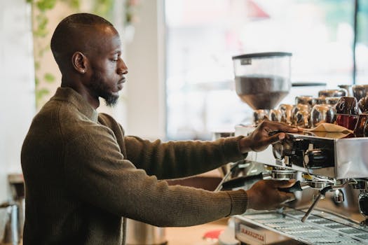 A barista expertly brews coffee on an espresso machine in a warm, inviting cafe environment.