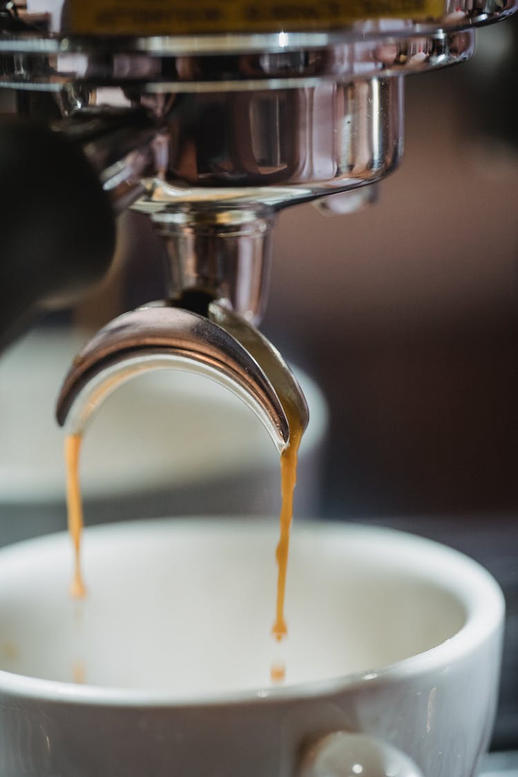 Coffee Dripping From Coffee Machine To Cup