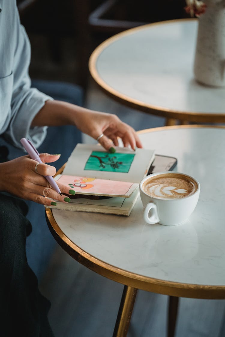 Woman Relaxing In Cafe With Coffee