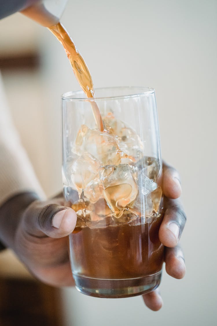 Close Up Of Barista Hands Preparing Iced Coffee