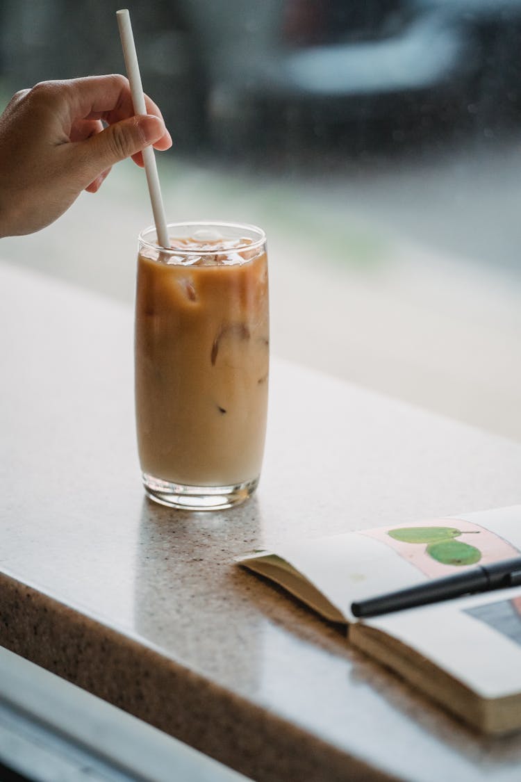 Close Up Of Barista Hands Preparing Iced Coffee