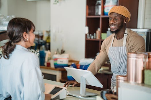 A cheerful barista engaging with a customer at a café counter, creating a welcoming atmosphere.