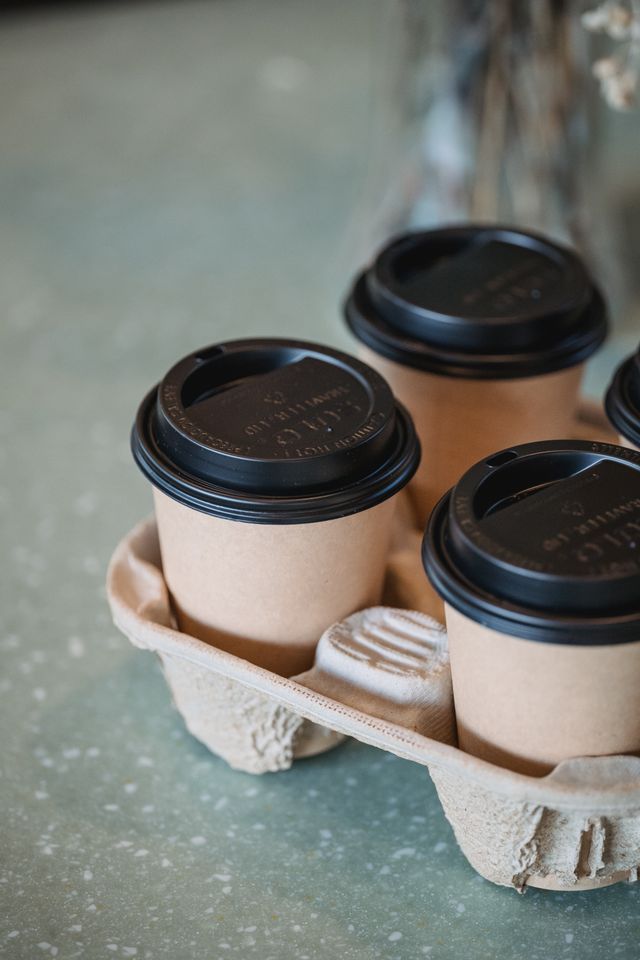 Plain kraft takeaway coffee cups in a molded carrier