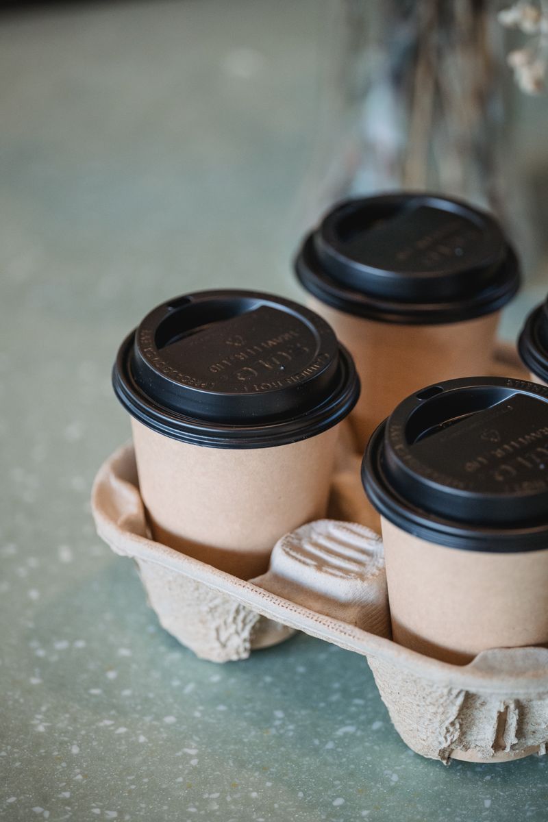 Plain kraft takeaway coffee cups in a molded carrier