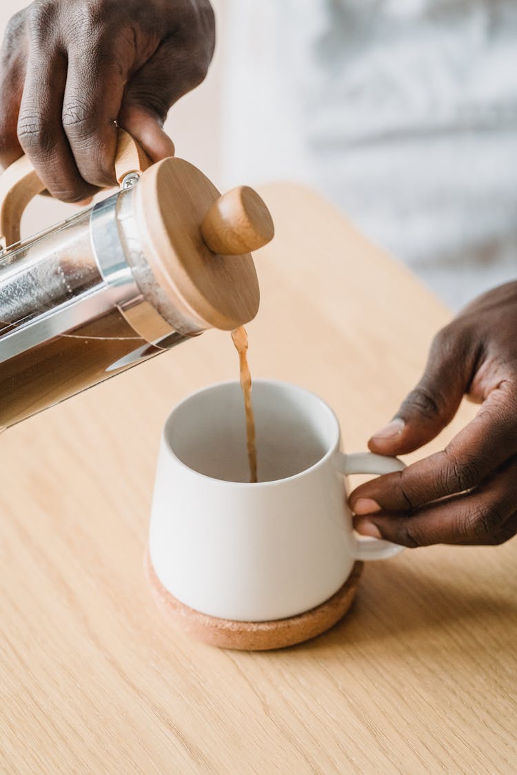 Man Pouring Coffee To Cup