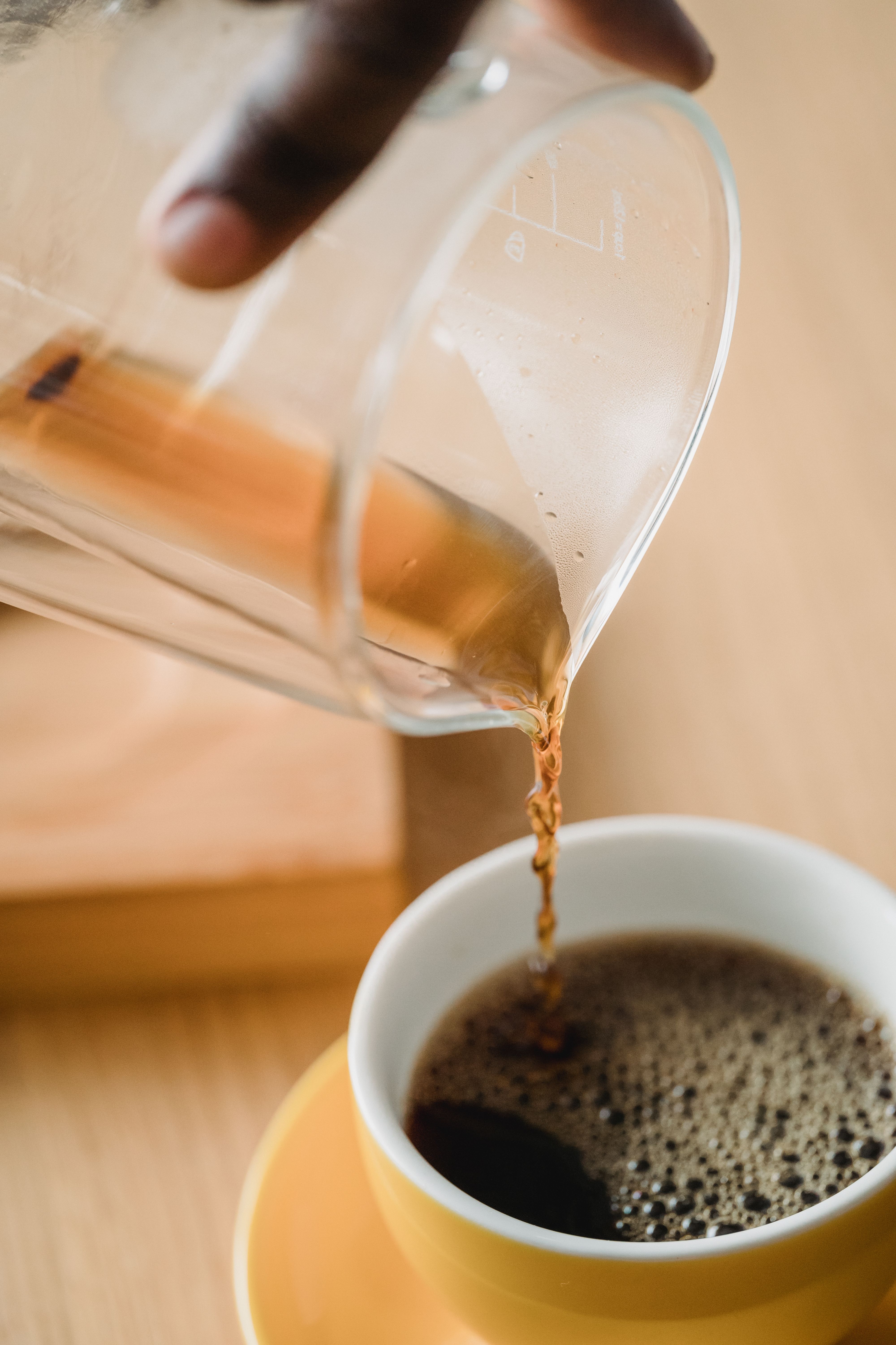 Person Pouring Black Ink in a Small Cup · Free Stock Photo