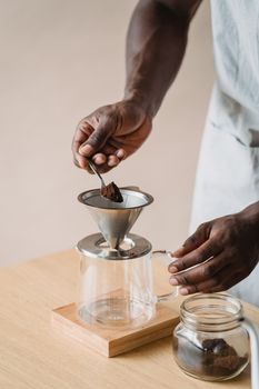 Person Pouring Water on Silver Cup