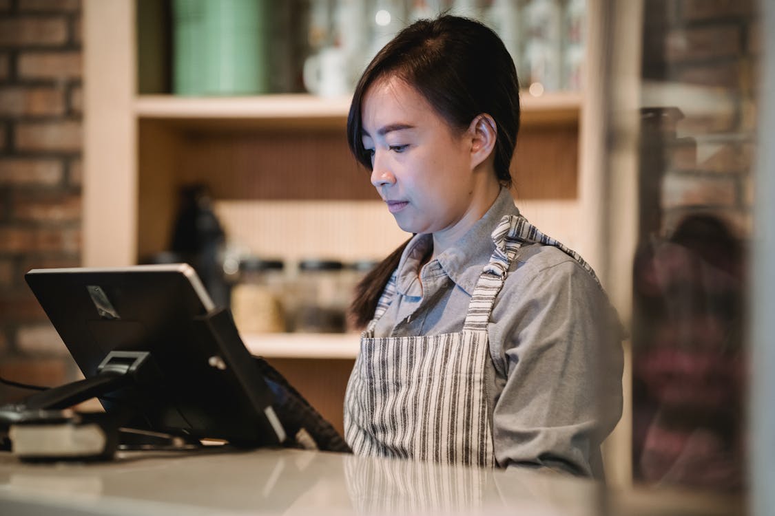 Free Woman Working at Cash Register Stock Photo