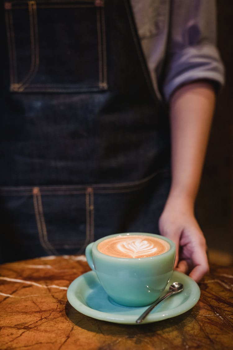 Barista Serving Coffee With Foam