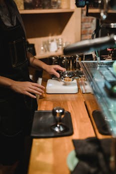 Barista crafting espresso with precision at a modern coffee shop counter.