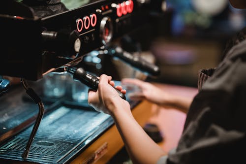 Woman Using Coffee Machine