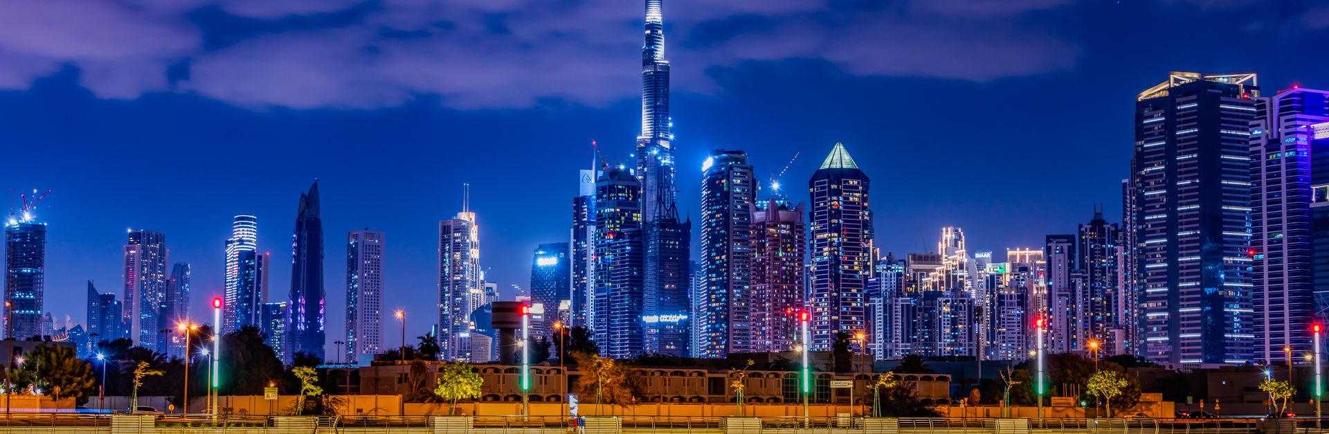 Captivating night view of Dubai's skyline featuring the illuminated Burj Khalifa under a vibrant nig
