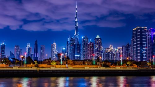 Free Captivating night view of Dubai's skyline featuring the illuminated Burj Khalifa under a vibrant night sky. Stock Photo
