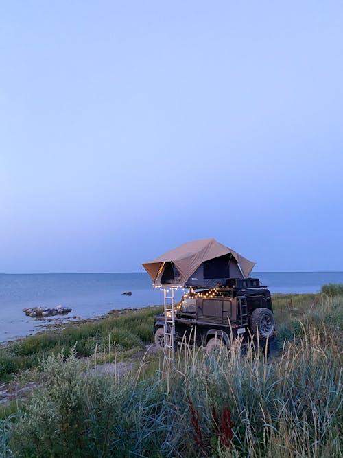 Jeep with a Tent on the Roof, Parked on a Seaside