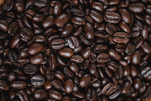 Free Close-up of dark roasted coffee beans, perfect for background or texture use. Stock Photo
