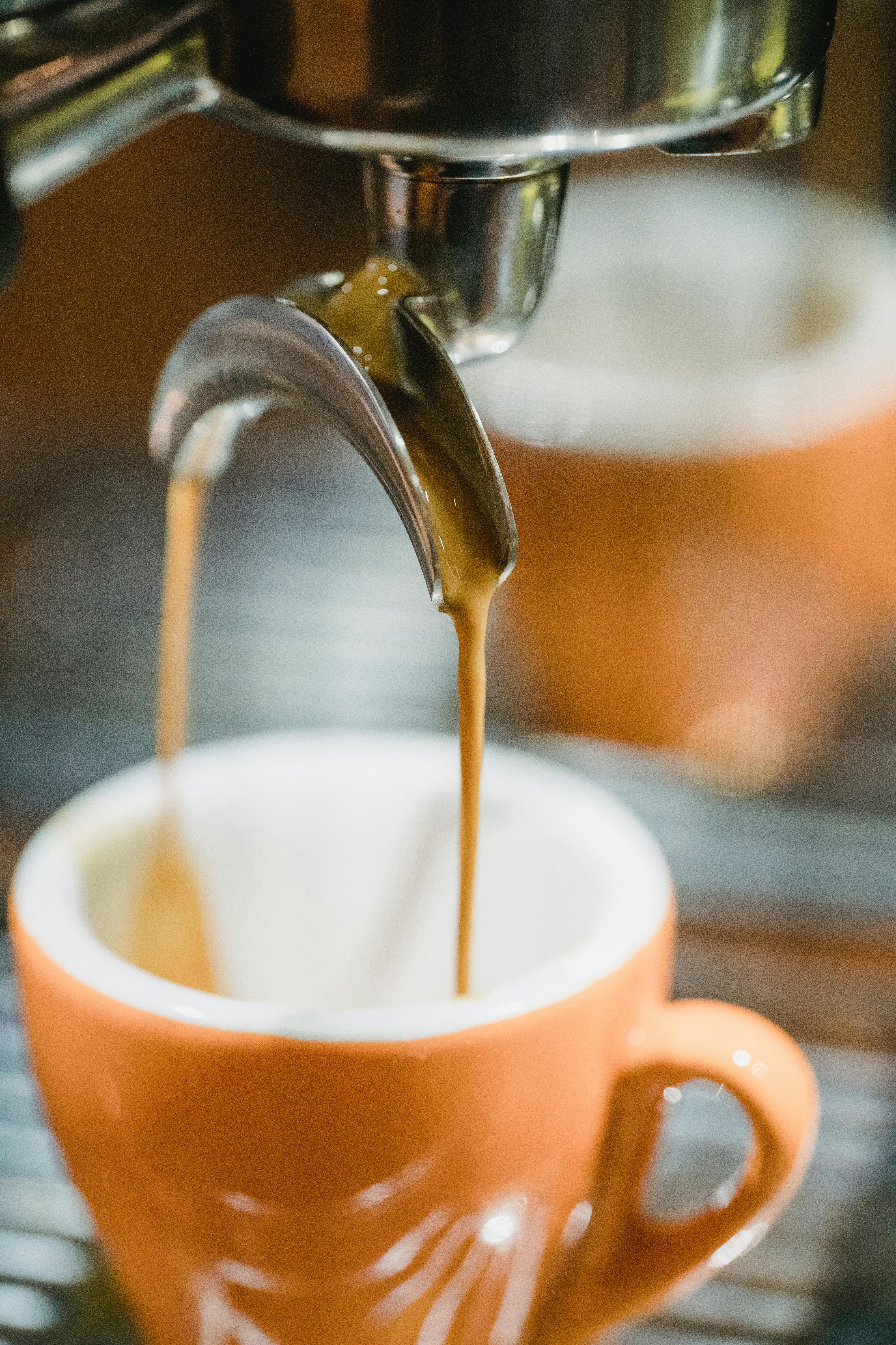 coffee extraction, drops, hot beverage, espresso dripping into cups,  professional coffee machine Stock Photo by LightFieldStudios