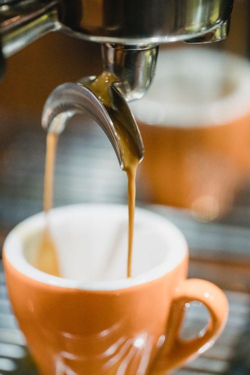 Free Detailed view of espresso flowing from machine into cup. Stock Photo