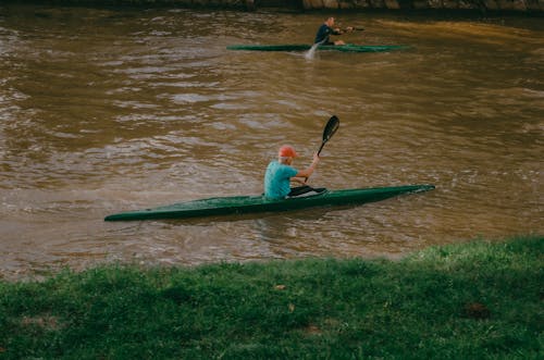 Father and Son Riding a Kayak on the River