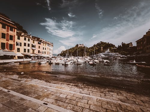 Brown Concrete Building Near River with Boats