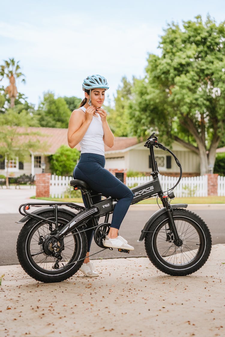 Woman With Helmet On A Bike In A Residential Area