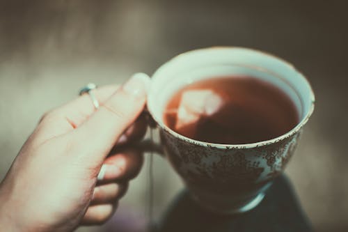 Person Holding Tea Cup