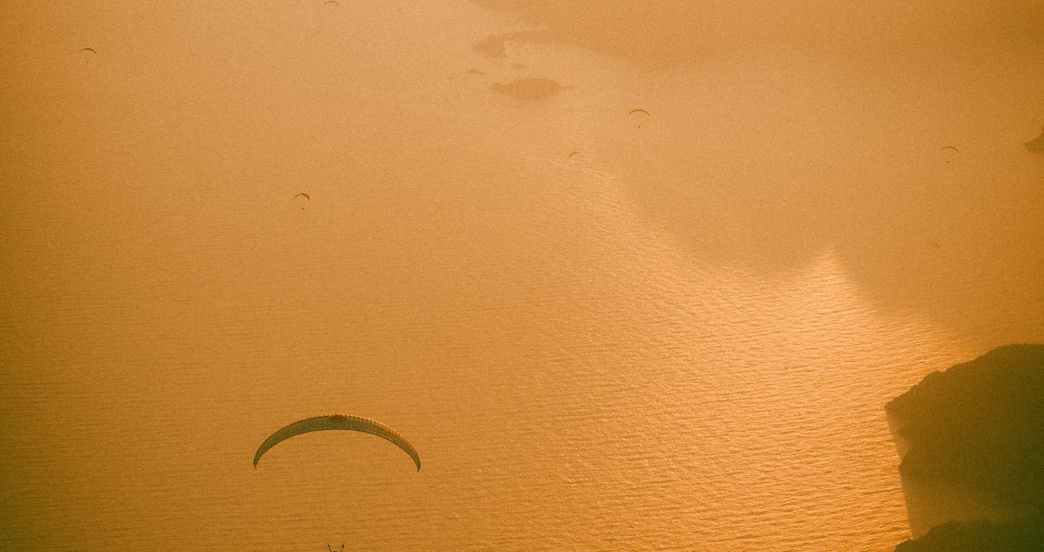 Silhouette of Person Riding on Boat on Water