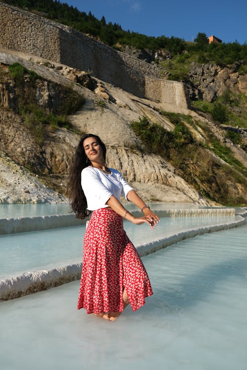 Woman in White Shirt and Red Skirt