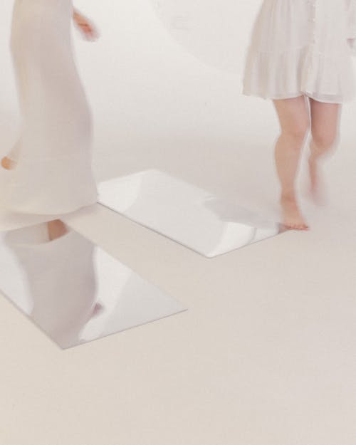 Women in White Dresses Walking on a White Floor