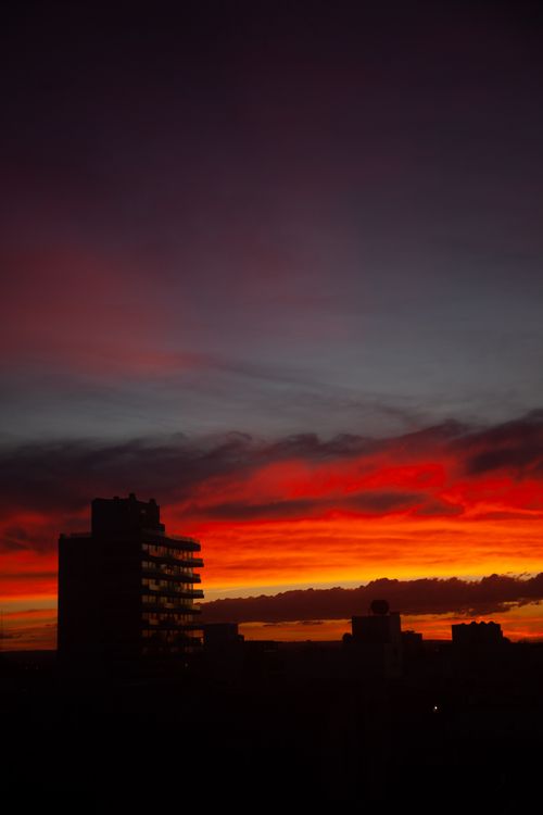 Free Silhouette of buildings against a vibrant sunset sky in Mar del Plata, Argentina. Stock Photo