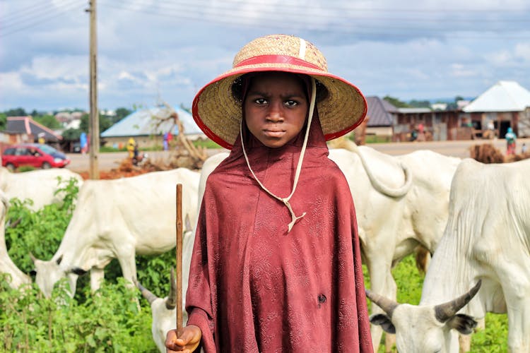 Photo Of A Child Holding A Brown Stick