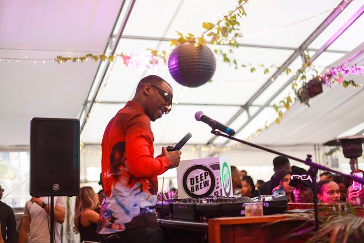 A DJ Holding His Headphones At A Party