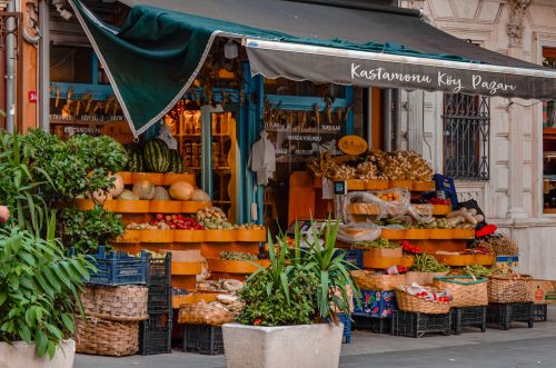 Free Colorful market stall displaying a variety of fresh fruits and vegetables. Stock Photo