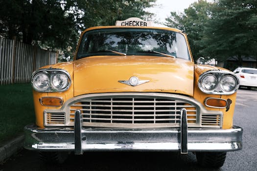 Classic yellow Checker taxi parked on an urban street, showcasing iconic vintage automotive design.
