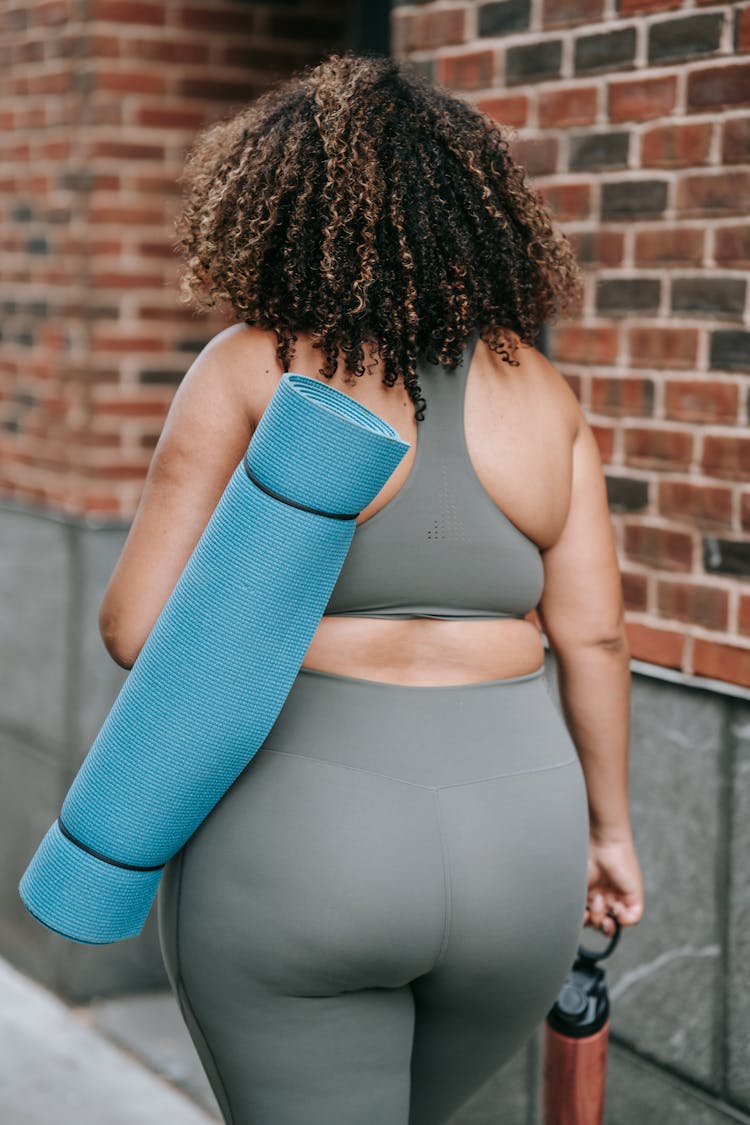 Woman Carrying Mat