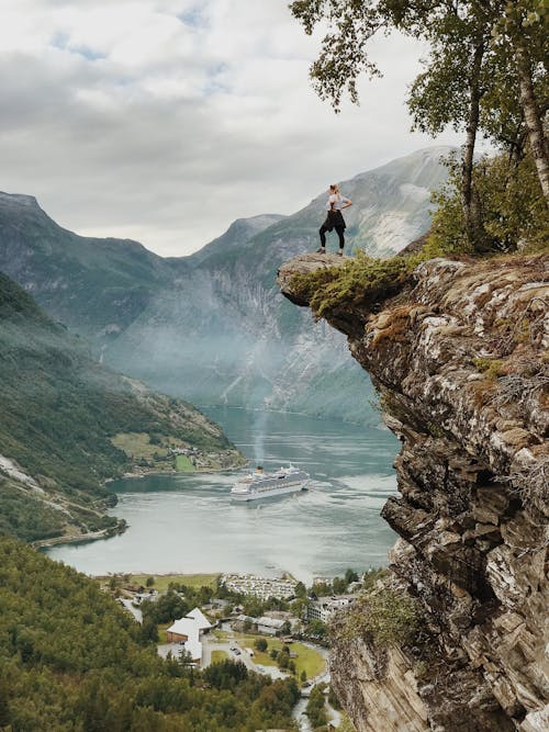 Free Woman Standing on the Cliff Stock Photo