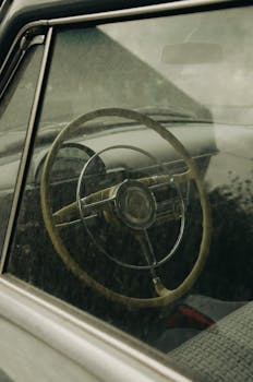 Close-up of a vintage car's steering wheel shot through the window in Baku, Azerbaijan.