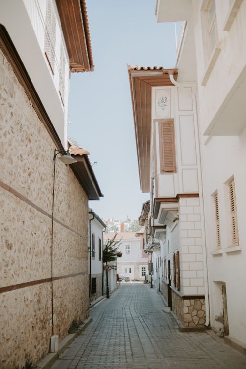 Free Discover a quaint narrow street lined with historic buildings, perfect for exploring history. Stock Photo