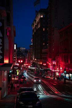 City lights illuminate a busy San Francisco street at night, capturing urban vibrancy.