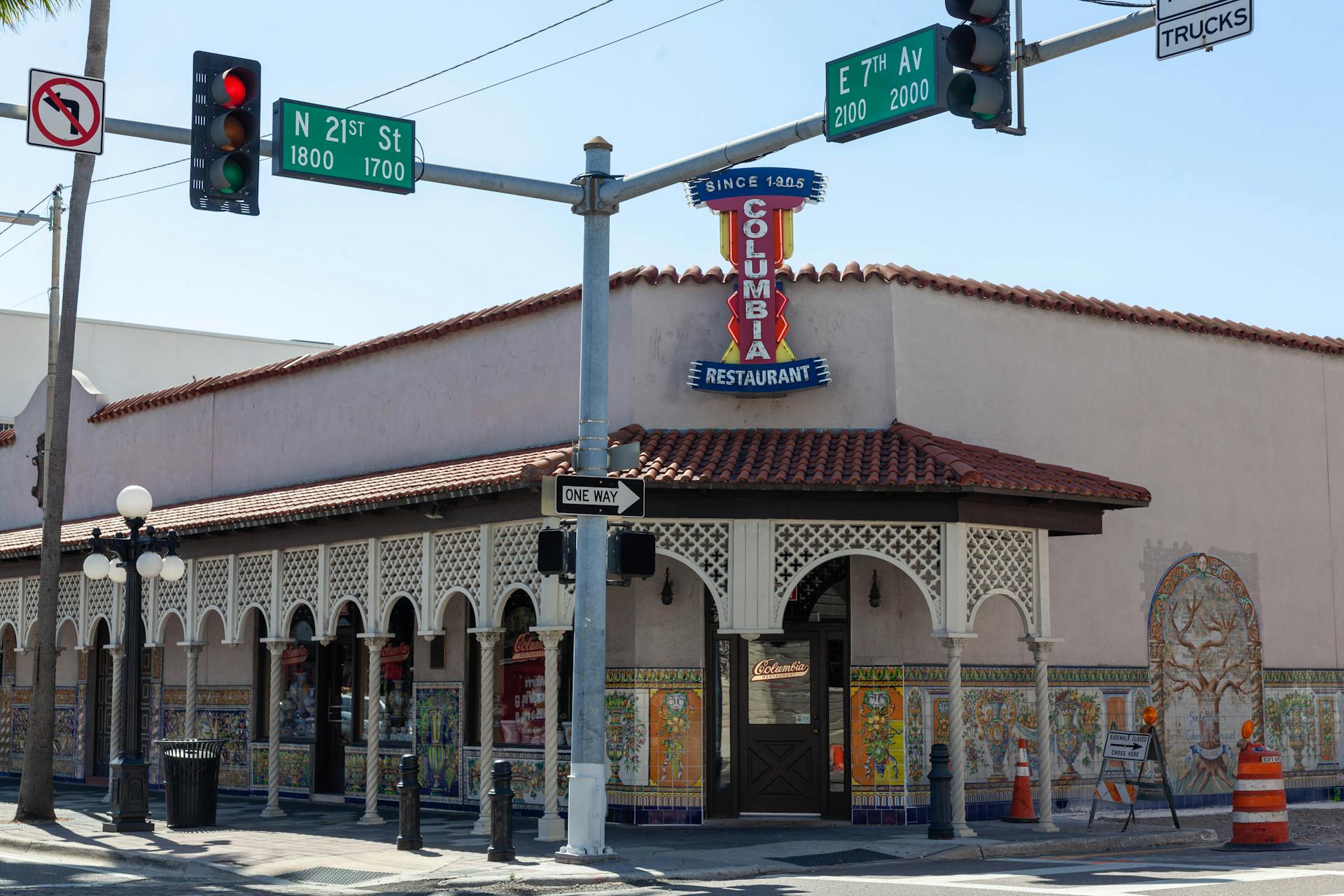 View of the iconic Columbia Restaurant at a busy street intersection in Tampa, Florida.